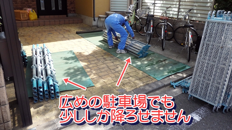 足場の荷物を降ろす職人