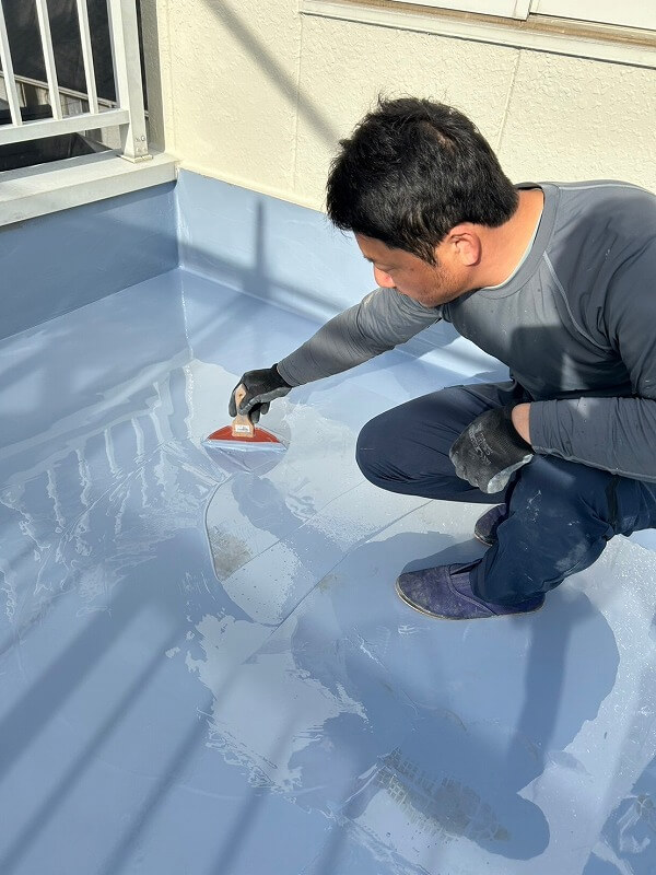 防水材を床に流し、丹念に伸ばしていきます。